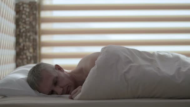 A frustrated man lies in bed after an unsuccessful sex — Stock Video