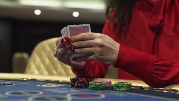 Gaming cards in the casino in womens hands — Stock Video