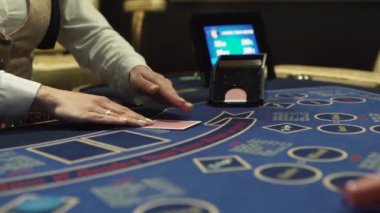 Dealer hands out cards at the gaming table
