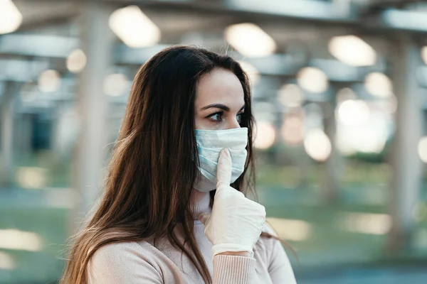 Ein junges Mädchen mit Schutzmaske zeigt mit dem Finger auf die Maske — Stockfoto