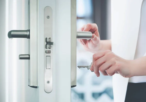 Locking or unlocking door with key in hand — Stock Photo, Image