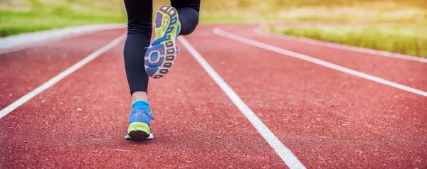 Athletic woman feet on running track close up on shoe