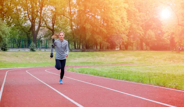 Athletic woman running on track, healthy lifestyle — Stock Photo, Image