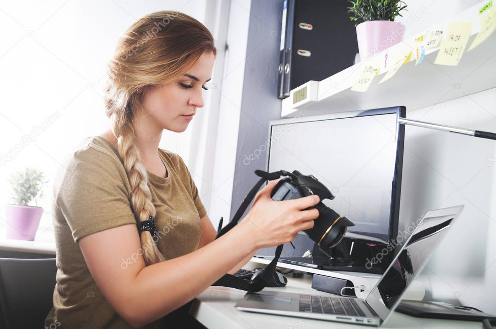 Freelance photographer woman with camera at home office editing 