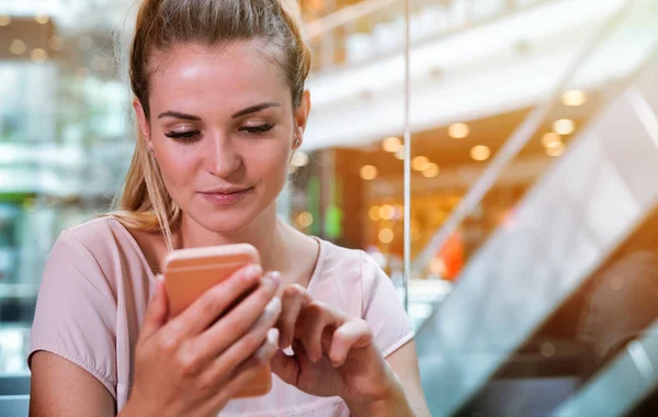 Chica usando el teléfono móvil en la cafetería en el centro comercial —  Fotos de Stock