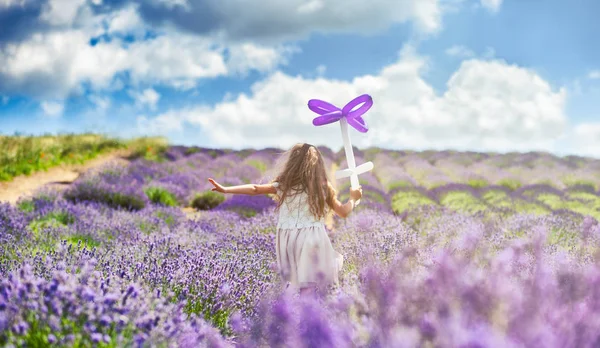 Bonita niña corre con globo de flores en el campo de lavanda, concepto de libertad —  Fotos de Stock