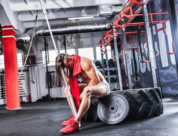 Muscular fit bodybuilder like Spartan warrior working out in gym