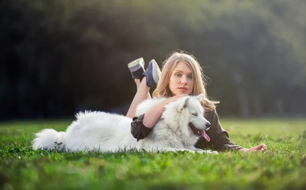 Pretty girl with dog on grass — Stock Photo, Image