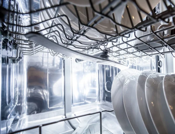 Interior of dishwasher machine with clean dishes — Stock Photo, Image