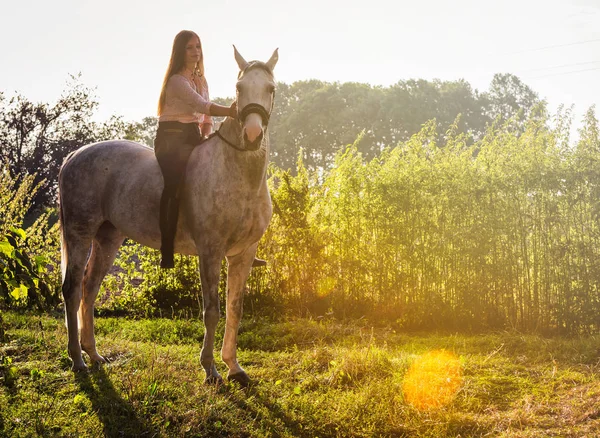 Woman riding a horse on farm at countryside — Stock Photo, Image