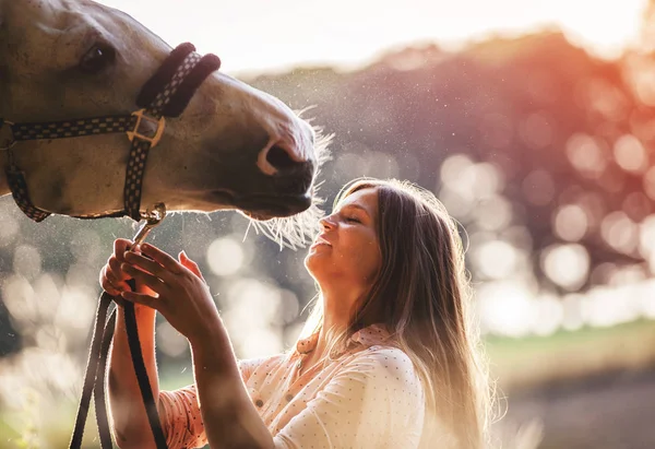 Woman with her horse at sunset, autumn scene — Stock Photo, Image