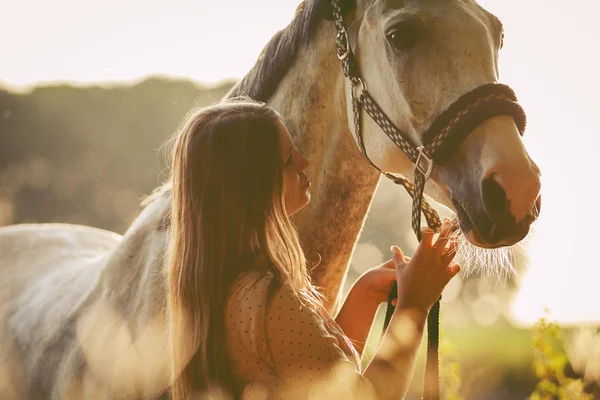 Woman with her horse at sunset, autumn scene — Stock Photo, Image