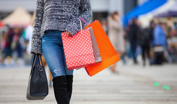 Закрытие сумки с покупками, которую женщина носит на улице — стоковое фото