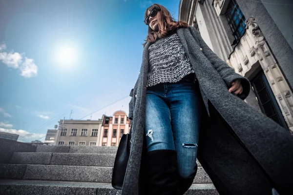 Casual fashion urban scene, trendy woman in coat walking on the street — Stock Photo, Image