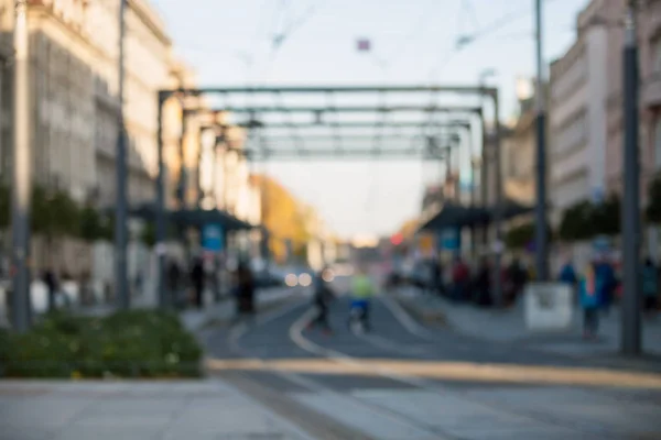 Blurred people walking through city street, bokeh background — Stock Photo, Image