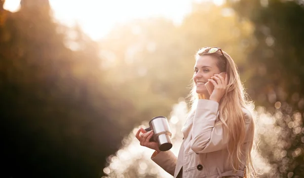 Modern woman in rush walking on street using smartphone outdoor — Stock Photo, Image