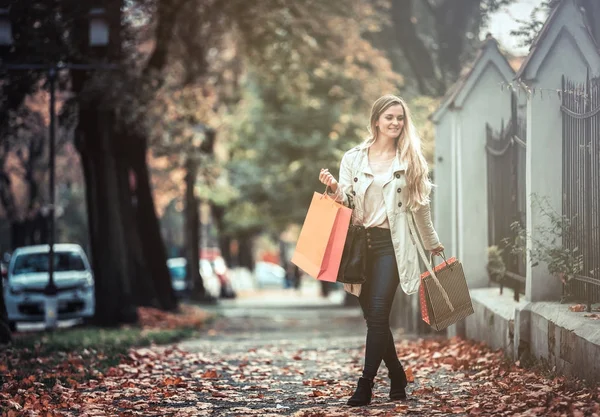 Mujer con bolsas de compras caminando por la ciudad, día casual auténtica — Foto de Stock