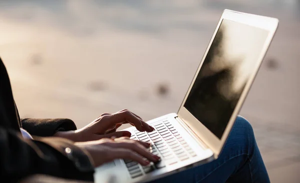 Закройте экран ноутбука, женщина использует компьютер на улице города — стоковое фото