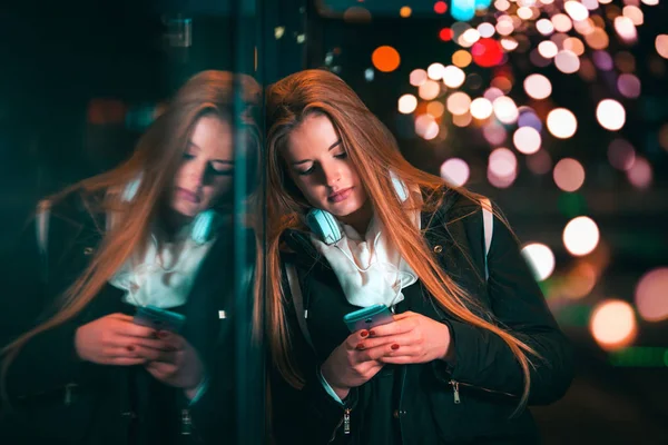 Belle femme la nuit dans la ville parmi les lumières colorées — Photo