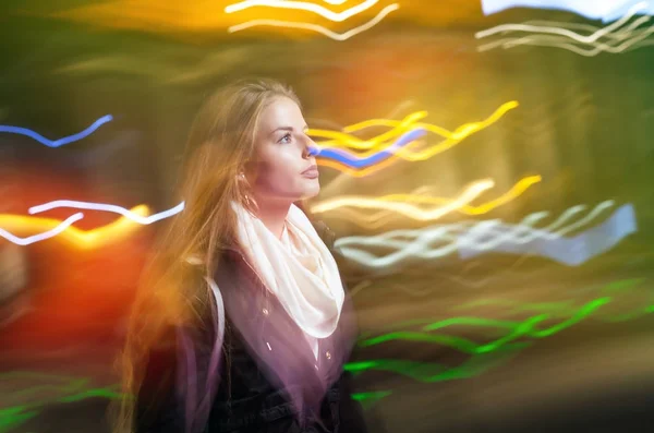 Woman in city at night among neon moving lights — Stock Photo, Image