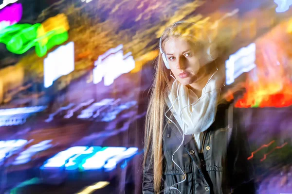 Woman in city at night among neon moving lights, fashion portrait — Stock Photo, Image