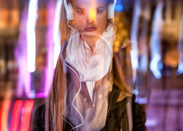 Woman in city at night among neon moving lights, fashion portrait — Stock Photo, Image