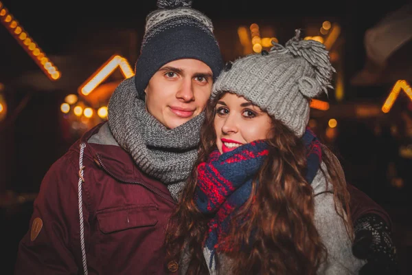 Jeune couple marchant le soir sur le marché de Noël traditionnel, place de la fée — Photo