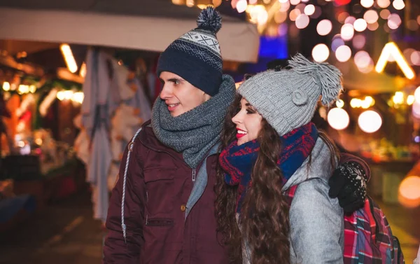 伝統的なクリスマス マーケット、妖精の場所に夜歩く若いカップル — ストック写真