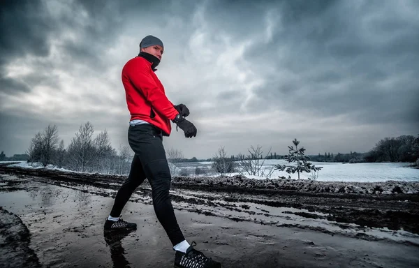 Athlete wearing warm sporty running clothes, winter exercise outdoor Stock  Photo by ©leszekglasner 180855070