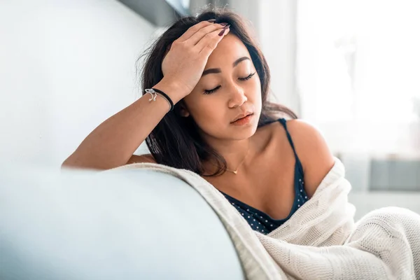 Sad lonely depressed asian woman on sofa at home — Stock Photo, Image