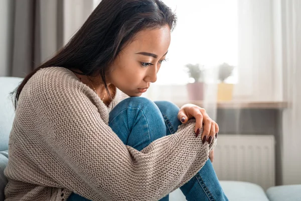 Sad lonely depressed asian woman on sofa at home — Stock Photo, Image