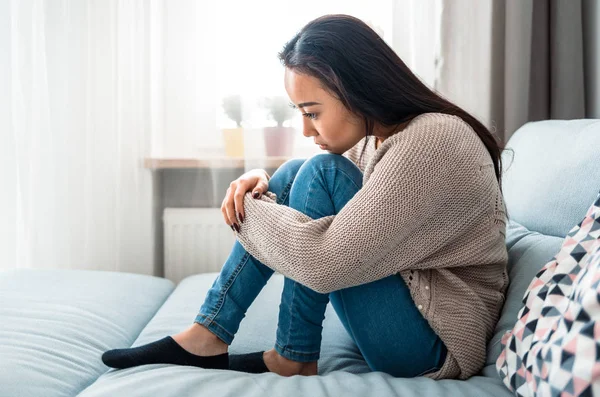 Sad lonely depressed asian woman on sofa at home — Stock Photo, Image