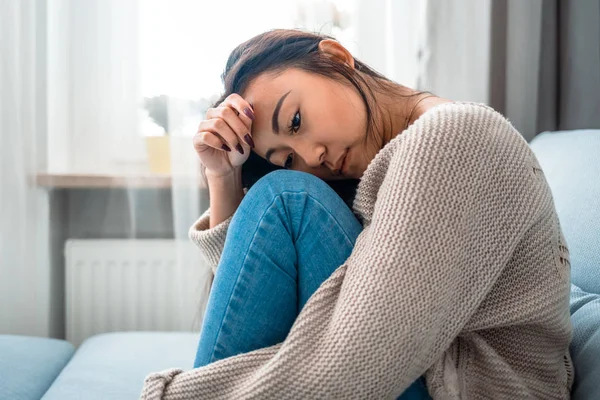 Sad lonely depressed asian woman on sofa at home — Stock Photo, Image