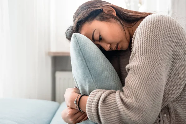 Unhappy lonely depressed asian woman on sofa at home — Stock Photo, Image