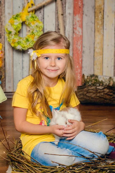 Little girl with bunny for Easter holiday in yellow smile — Stock Photo, Image