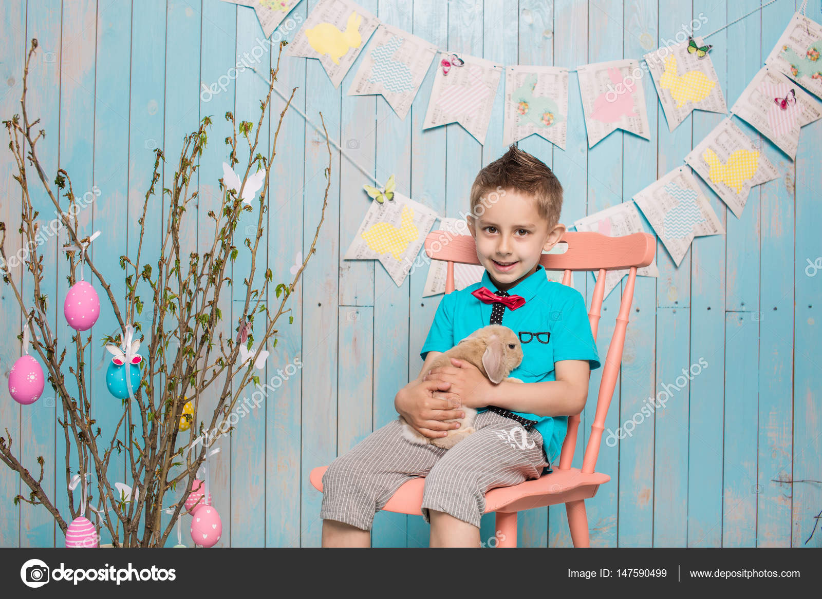 Little Boy Brother Along With Rabbit Sitting On The Floor Or Chair