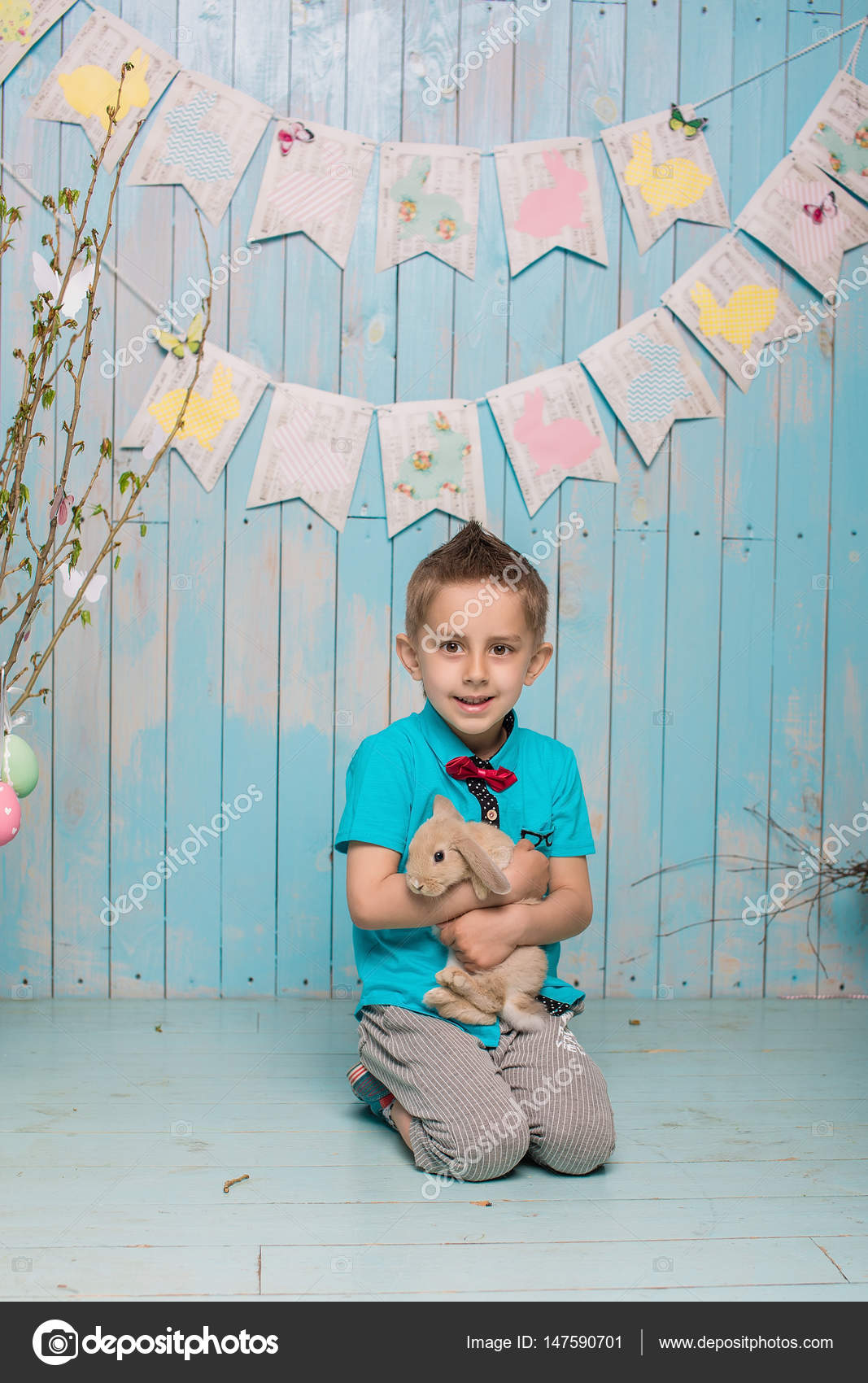 Little Boy Brother Along With Rabbit Sitting On The Floor Or Chair