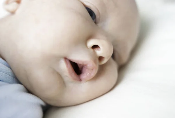 Baby European Appearance Lies Bed Face Close — Stock Photo, Image