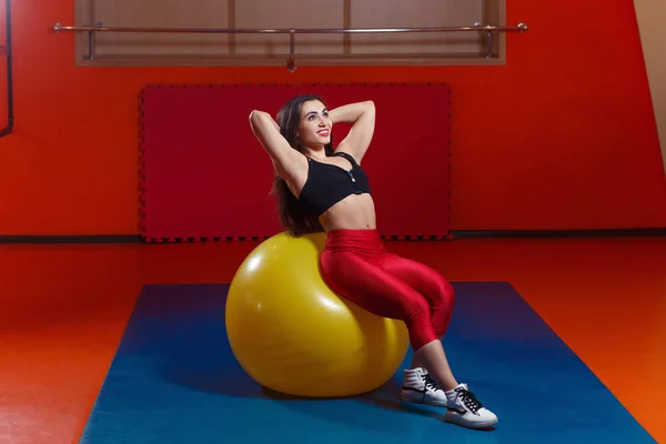 Mulher muito sorridente treinando músculos abdominais em b amarelo grande — Fotografia de Stock