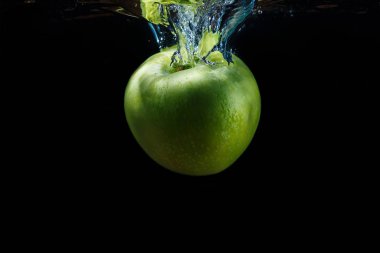 Su sıçrama siyah bir arka plan ile yeşil elma