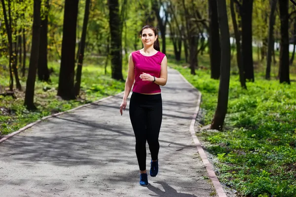 Jeune jolie femme en forme jogging dans le parc . — Photo