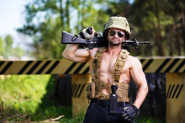 Powerful mercenary with submachine gun guarding a roadblock