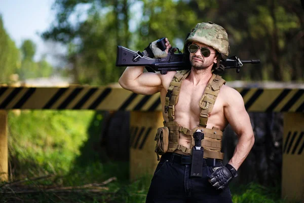 Powerful mercenary with submachine gun guarding a roadblock