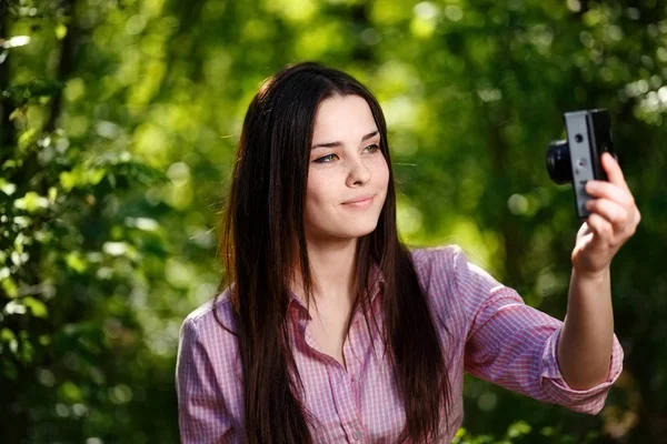 Ung vacker flicka tar selfie med retro filmkamera — Stockfoto