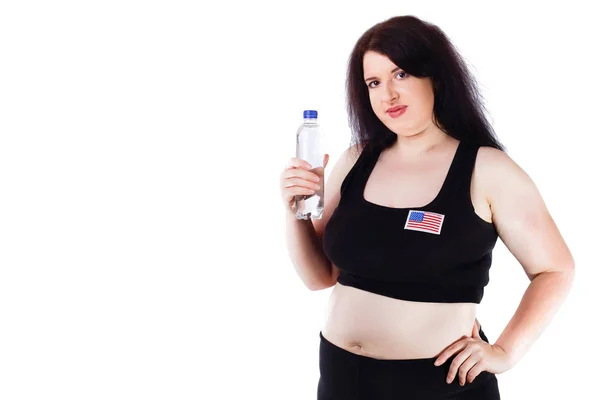 Молода надмірна вага спрагнена жінка з пляшкою води, студія с — стокове фото