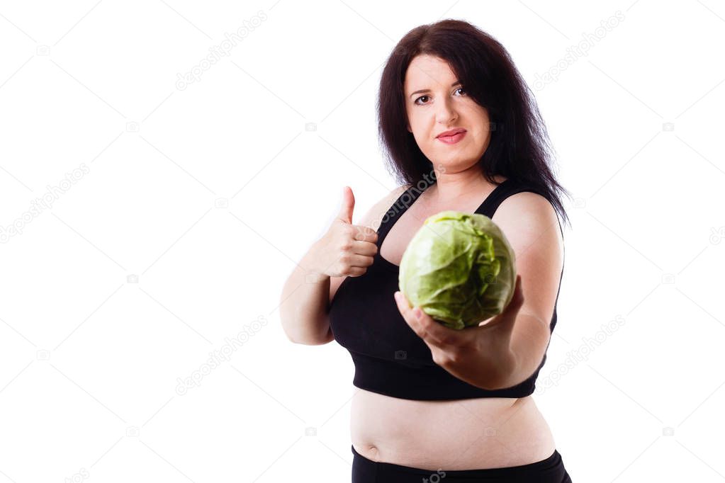 overweight woman with cabbage and thumb up gesture