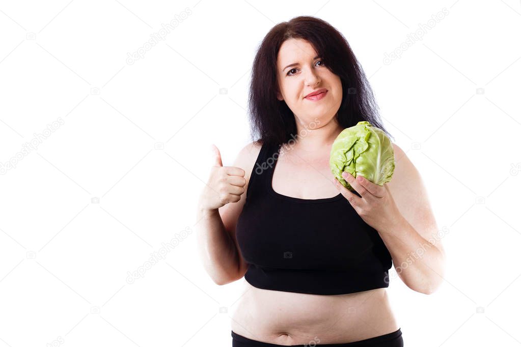 Young overweight smiling woman agitating for healthy food with c