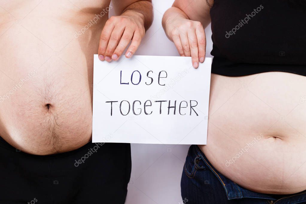 Man and woman,overweight couple standing close