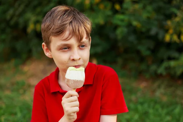 Boy enjoys eating ice-cream. Childhood, family, people, sweets c