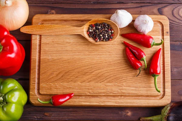 Food background with chopping board, spices and vegetables. Free
